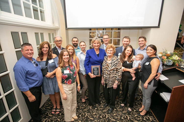 Nancy Wilson is surrounded by her employees and family after accepting the Big Shoes award.