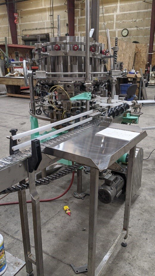 Photo of a automated piece of filling equipment.