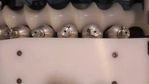 Inline Orienting System for Precise Container Alignment