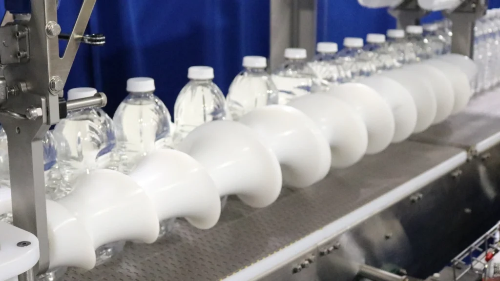 Turning and Dividing System for Warm-Filled Plastic Juice Bottles