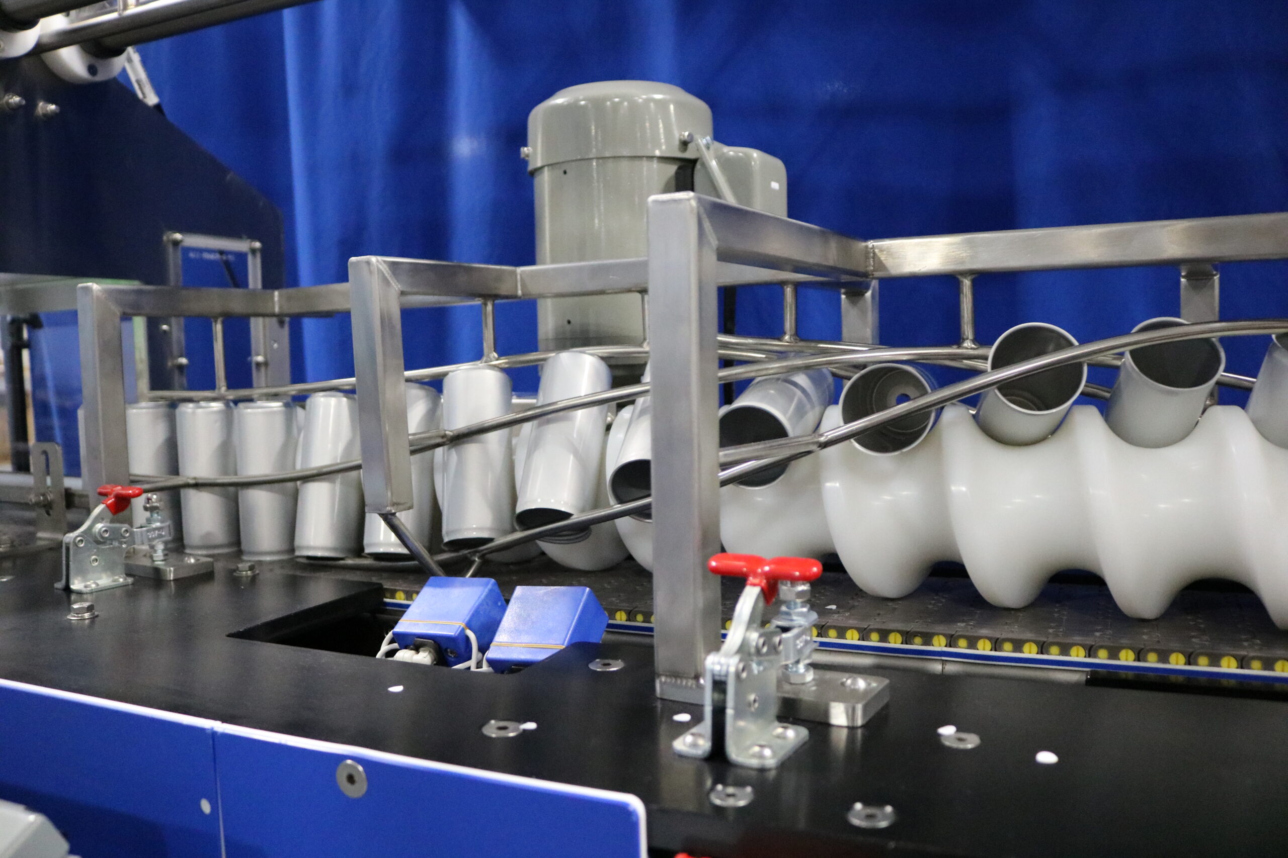 Cans being inverted by a power twist.